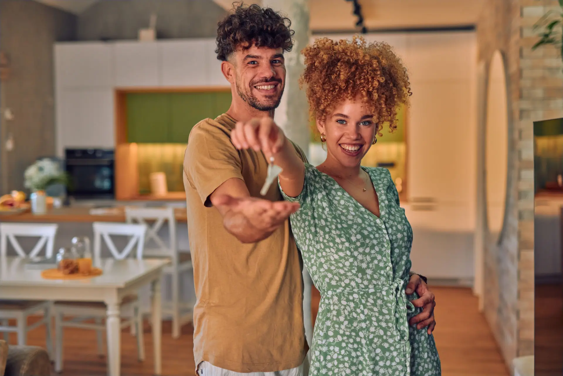 Happy couple holding keys after closing on their FHA Home Loan