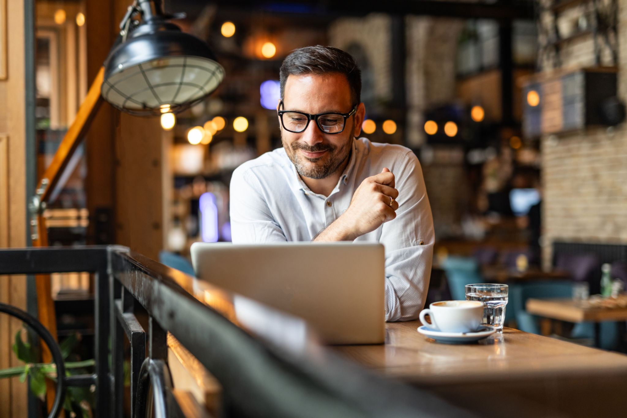 A diverse couple or small business owner sitting at a kitchen tabl